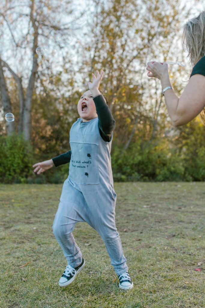 A child joyfully playing with bubbles in a park, capturing a moment of carefree fun.