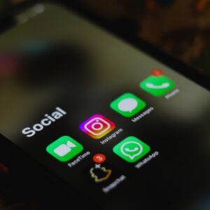 A close-up shot of smartphone displaying social media apps icons on screen.